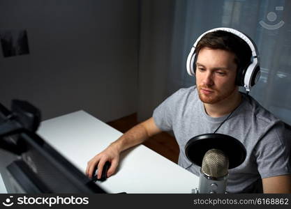 technology, gaming, entertainment, let&amp;#39;s play and people concept - young man in headset with pc computer playing game at home and streaming playthrough or walkthrough video