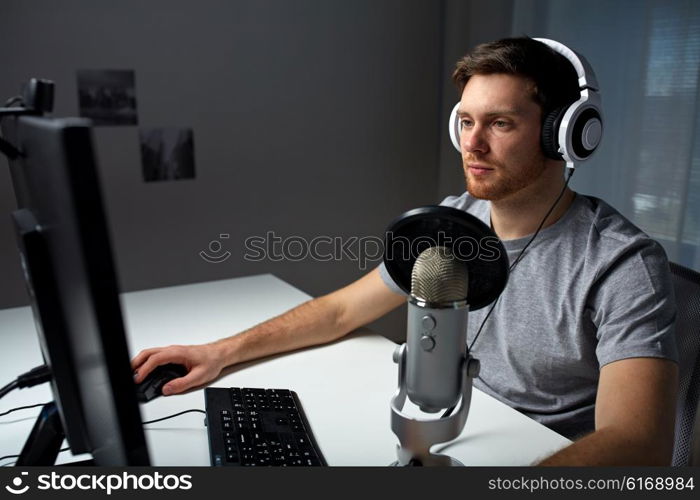 technology, gaming, entertainment, let&amp;#39;s play and people concept - young man in headset with pc computer playing game at home and streaming playthrough or walkthrough video