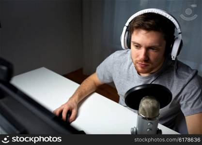 technology, gaming, entertainment, let&amp;#39;s play and people concept - young man in headset with pc computer playing game at home and streaming playthrough or walkthrough video