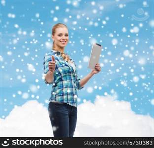 technology, gesture and people concept - smiling girl with tablet pc computer showing thumbs up over blue snowy sky and cloud background