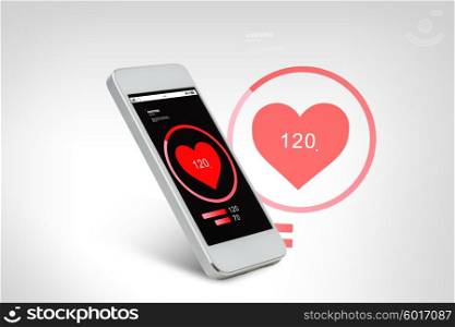 technology, health care, application and electronics concept - white smarthphone with red heart icon screen