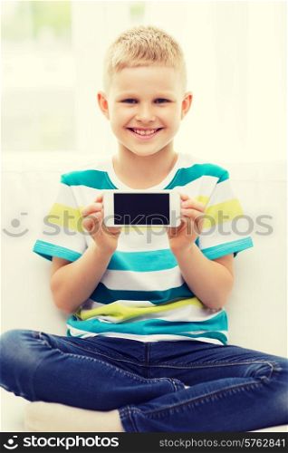 technology, home, advertising and childhood concept - little boy showing smartphone black blank screen at home