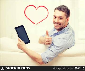 technology, home and lifestyle concept - smiling man working with tablet pc computer at home showing thumbs up