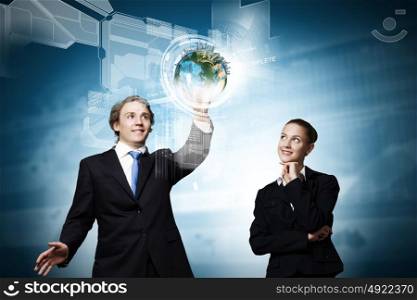 Technology innovations. Businessman and businesswoman touching icon of digital screen. Elements of this image are furnished by NASA