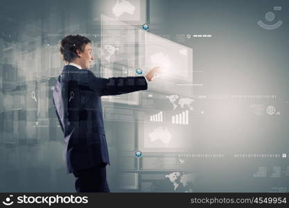 Technology innovations. Businessman in suit touching icon of media screen