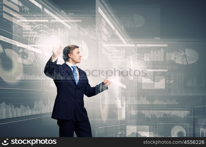 Technology innovations. Businessman in suit touching icon of media screen