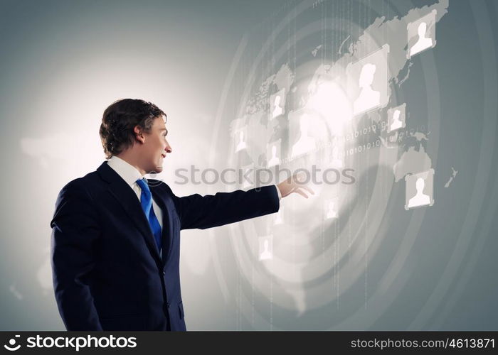 Technology innovations. Businessman in suit touching icon of media screen