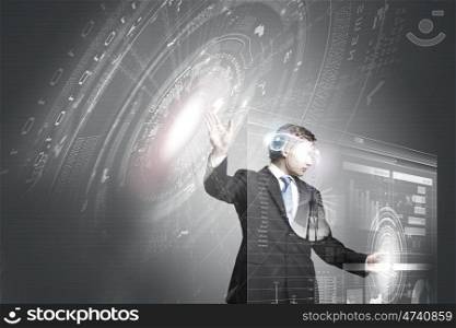 Technology innovations. Businessman in suit touching icon of media screen