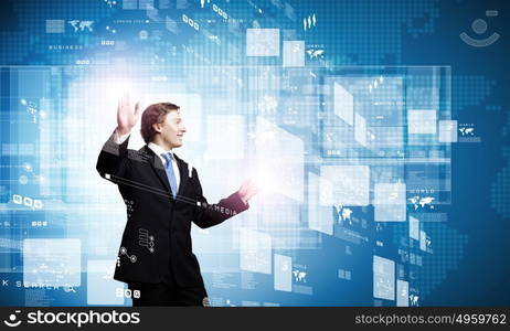 Technology innovations. Businessman in suit touching icon of media screen