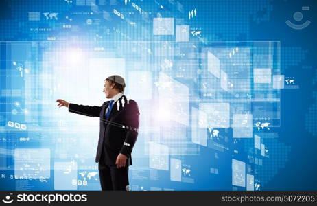 Technology innovations. Businessman in suit touching icon of media screen