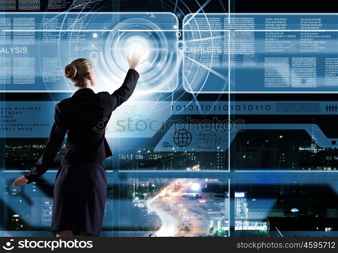 Technology innovations. Rear view of businesswoman touching icon of digital screen
