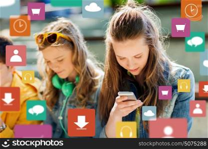 technology, internet addiction and people concept - happy teenage friends with smartphones outdoors. happy teenage friends with smartphones outdoors