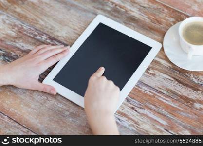technology, internet and home concept - close up of female pointing finger to black blank tablet pc computer screen