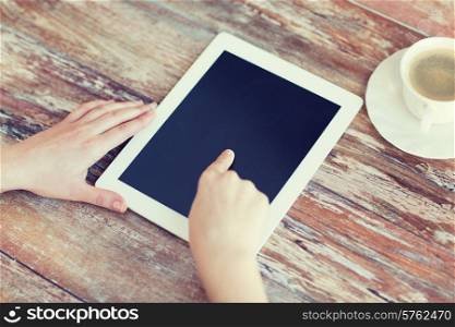 technology, internet and home concept - close up of female pointing finger to black blank tablet pc computer screen