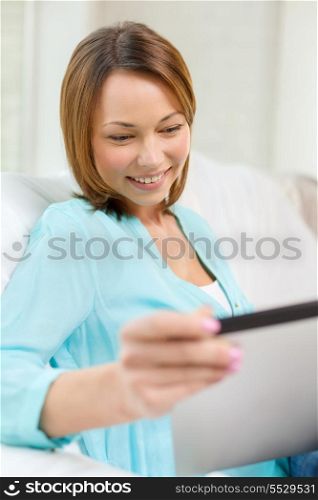 technology, internet and home concept - woman with tablet pc computer at home