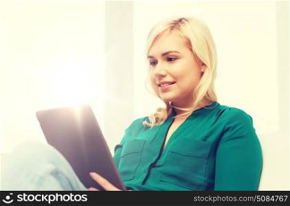 technology, internet and people concept concept - smiling woman sitting on couch with tablet pc computer at home. smiling woman with tablet pc at home. smiling woman with tablet pc at home
