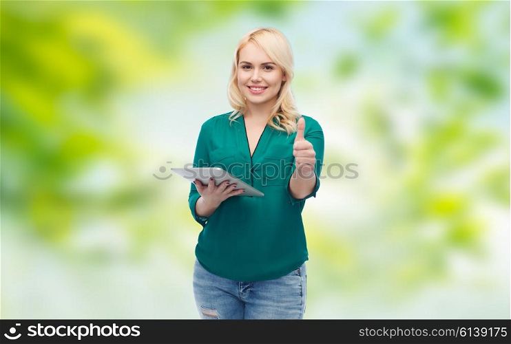 technology, internet and people concept concept - smiling woman with tablet pc computer showing thumbs up over green natural background