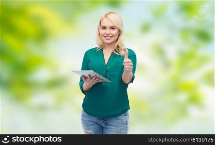 technology, internet and people concept concept - smiling woman with tablet pc computer showing thumbs up over green natural background
