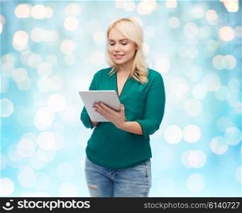 technology, internet and people concept concept - smiling woman with tablet pc computer over blue holidays lights background