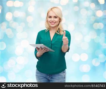 technology, internet and people concept concept - smiling woman with tablet pc computer showing thumbs up over blue holidays lights background