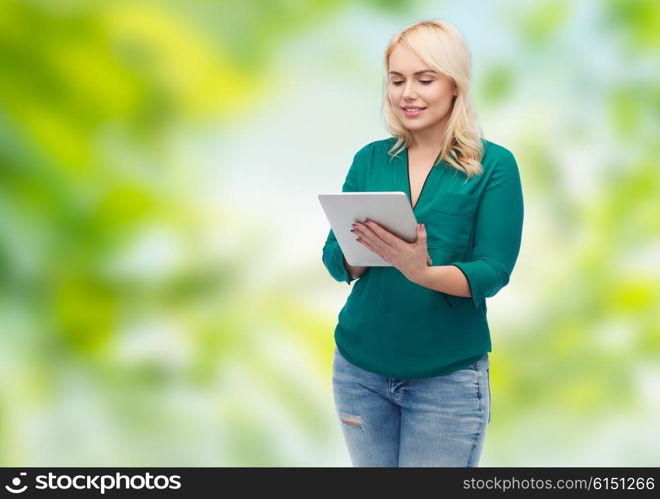technology, internet and people concept concept - smiling woman with tablet pc computer over green natural background