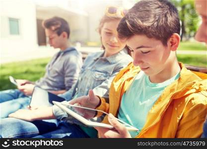 technology, internet and people concept - group of happy teenage friends or high school students with tablet pc computer outdoors. happy friends or students with tablet pc outdoors. happy friends or students with tablet pc outdoors