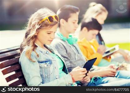 technology, internet and people concept - group of happy teenage friends or students with tablet pc computer outdoors. happy friends with tablet pc computer outdoors. happy friends with tablet pc computer outdoors