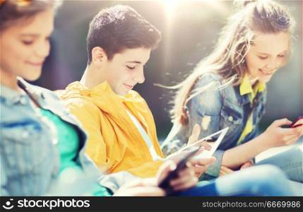 technology, internet and people concept - group of happy teenage friends or students with tablet pc computer outdoors. happy friends with tablet pc computer outdoors. happy friends with tablet pc computer outdoors