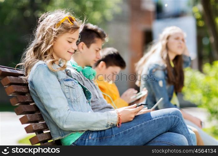 technology, internet and people concept - happy girl with tablet pc computer and group of teenage friends or students outdoors