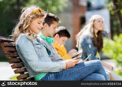 technology, internet and people concept - happy girl with tablet pc computer and group of teenage friends or students outdoors