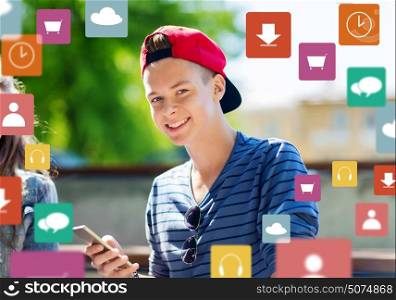 technology, internet and people concept - happy teenage boy with smartphone outdoors. happy teenage boy with smartphone outdoors