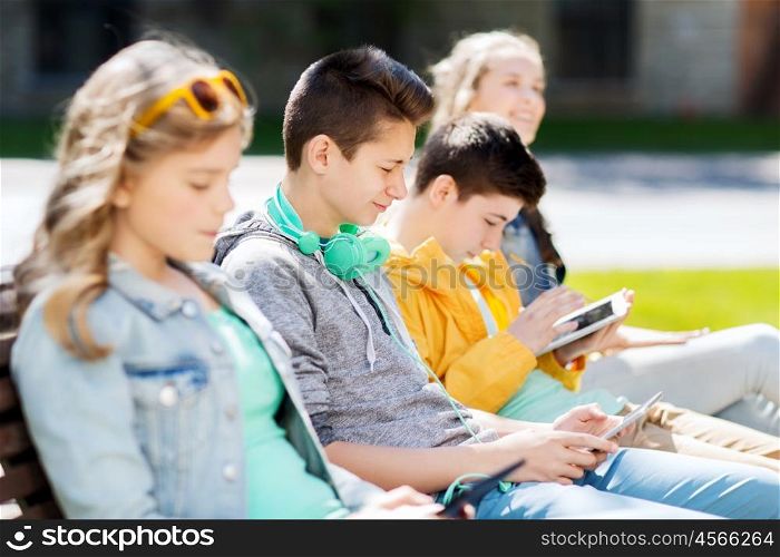 technology, internet and people concept - happy teenage boy with tablet pc computer and headphones outdoors