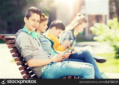 technology, internet and people concept - happy teenage boy with tablet pc computer and headphones outdoors. happy teenage boy with tablet pc and headphones. happy teenage boy with tablet pc and headphones