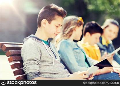 technology, internet and people concept - happy teenage boy with tablet pc computer outdoors. happy teenage boy with tablet pc computer outdoors. happy teenage boy with tablet pc computer outdoors
