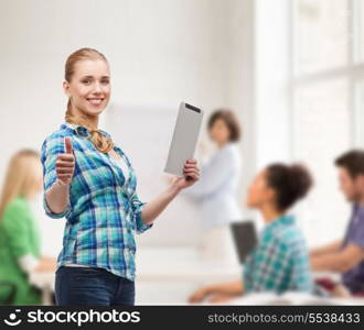 technology, internet and people concept - smiling girl with tablet pc computer showing thumbs up at classroom