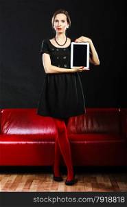 Technology internet business concept. Fashion woman retro style red lips nails showing tablet touchpad with copy space on black