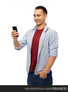 technology, internet, communication and people concept - happy man with smartphone over white background. happy man with smartphone over white background