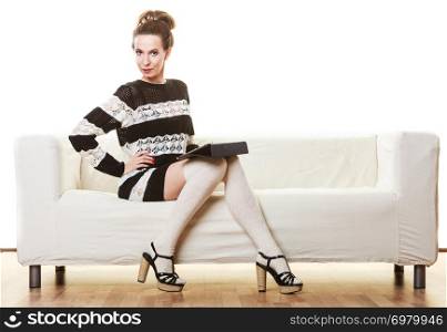 Technology internet concept. Fashion trendy woman sitting with tablet on white couch at home