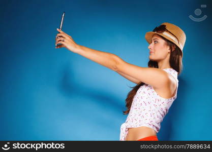 Technology internet modern lifestyle concept. Summer girl using digital tablet taking picture of herself. Selfie style. Woman with e-book reader touchpad pc.