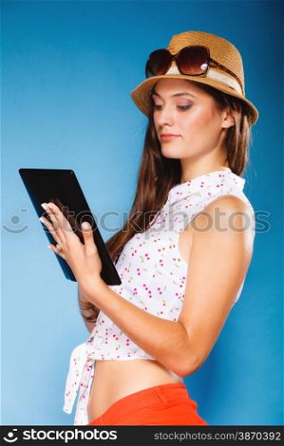 Technology internet modern lifestyle concept. Young summer girl using tablet computer reading. Latin female with e-book reader touchpad pc.