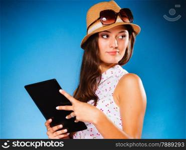 Technology internet modern lifestyle concept. Young summer girl using tablet computer reading. Latin female with e-book reader touchpad pc.
