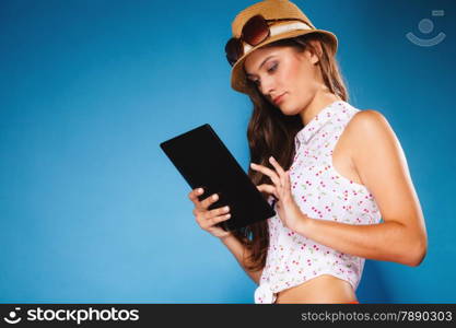 Technology internet modern lifestyle concept. Young summer girl using tablet computer reading. Latin female with e-book reader touchpad pc.