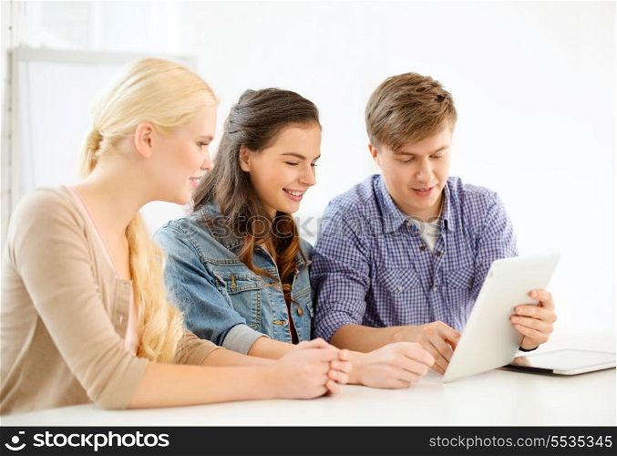 technology, internet, school and education concept - group of smiling teenage students with tablet pc computers at school
