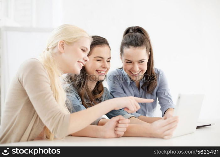 technology, internet, school and education concept - group of smiling teenage students with tablet pc computer at school