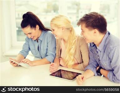 technology, internet, school and education concept - group of smiling teenage students with tablet pc computers at school
