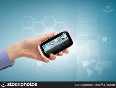 technology, internet, tv and news concept - woman hand with smartphone, videos and virtual screen