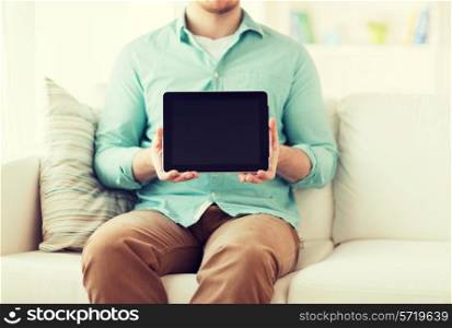 technology, leisure, lifestyle and advertisement concept - close up of man working with tablet pc computer sitting on sofa at home