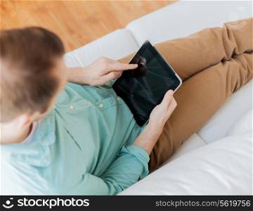 technology, leisure, lifestyle, distance learning and advertisement concept - close up of man working with tablet pc computer pointing finger at home