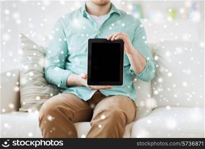 technology, leisure, people and advertisement concept - close up of man showing tablet pc computer screen sitting on sofa at home