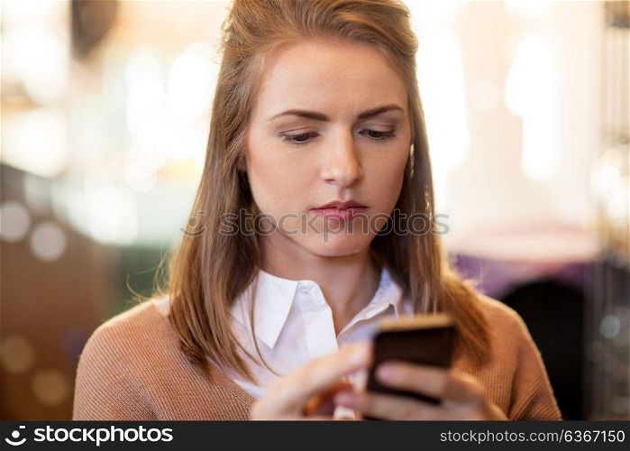 technology, lifestyle and people concept - close up of young woman with smartphone. close up of young woman with smartphone